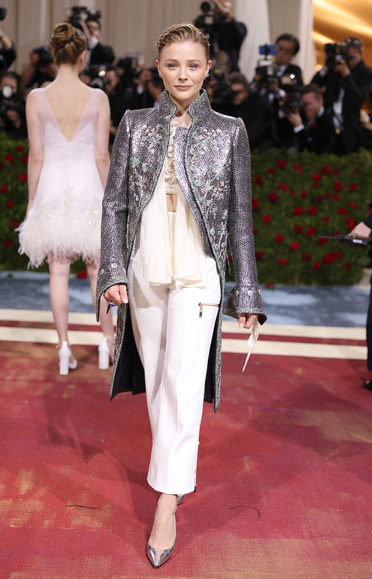 We love a celeb who understands the assignment! Chloe Grace Moretz wasn’t afraid to wear an unconventional, gender-bending look on this year’s Met Gala carpet. Her embellished tailcoat from the Louis Vuitton Spring 2018 collection is the epitome “Gilded Glamour.”