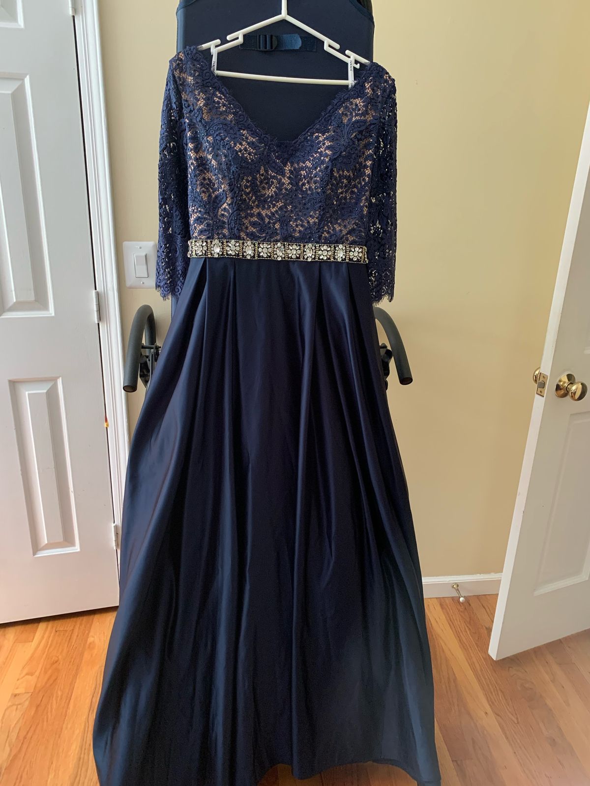 Jovani designed ballgown  it’s been used once in Gala                       Beaded lace waist up V-neck be back  Event in excellent condition three-quarter lace 3/4 sleeves with two side pockets beaded waste lace top Size 12 Lace Navy Blue Ball Gown on Queenly