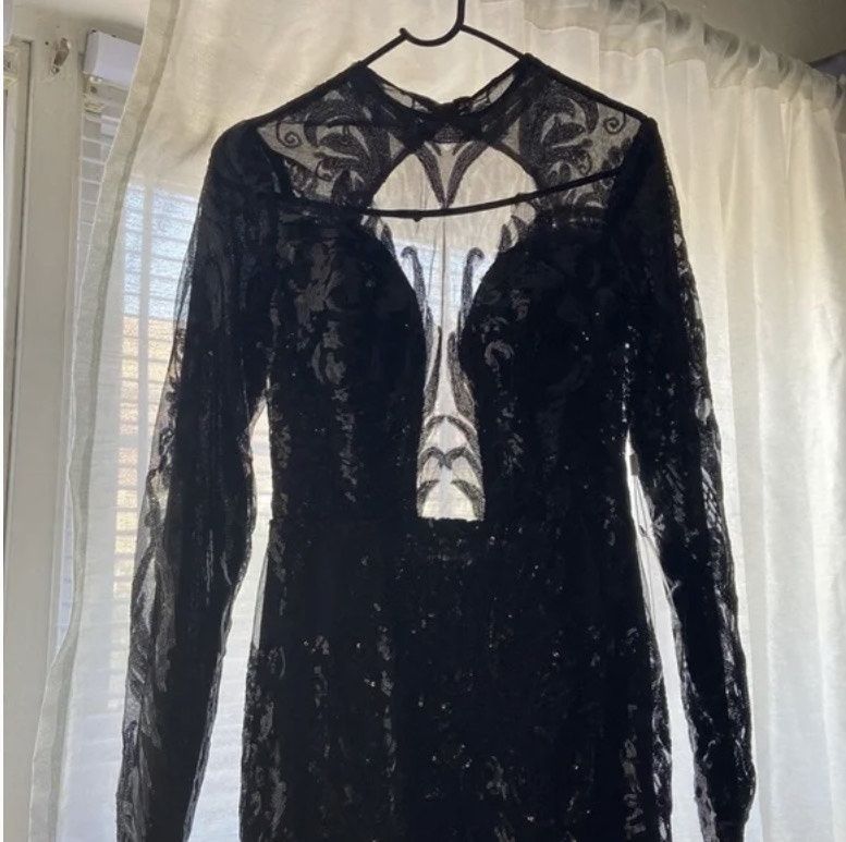 Style The back is out the bottom is see through with a long trail  Promgirl Size 8 Prom Long Sleeve Black Mermaid Dress on Queenly