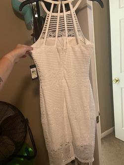 The brand is guess ivory cocktail dress. Very pretty. White Size 4 A-line Dress on Queenly